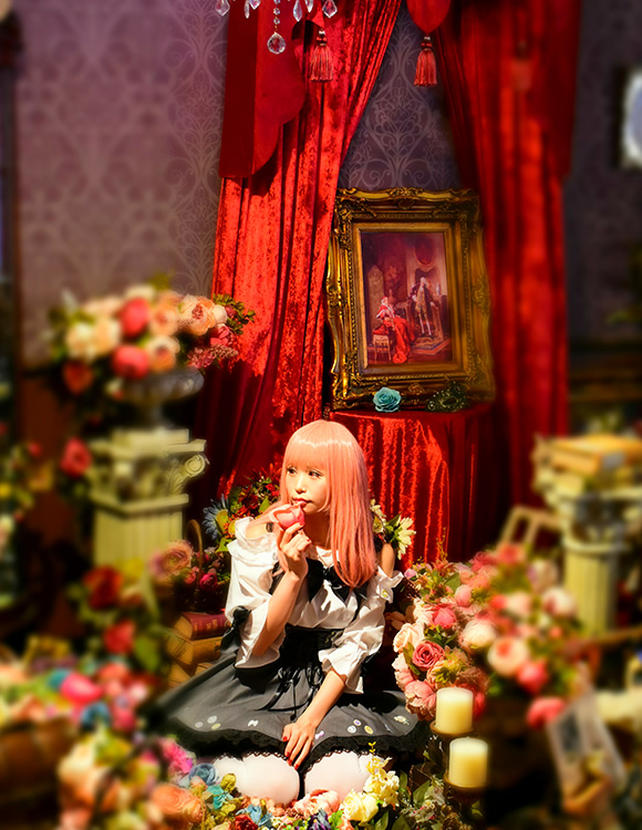 カメラ内蔵の画像加工機能「ミニチュア」で加工した、ドールハウスの人形のように見える女性の写真。