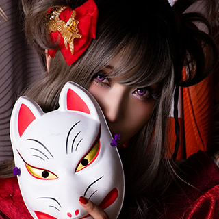 狐のお面で口元を隠してこちらを見つめる、赤い着物の女性の写真。