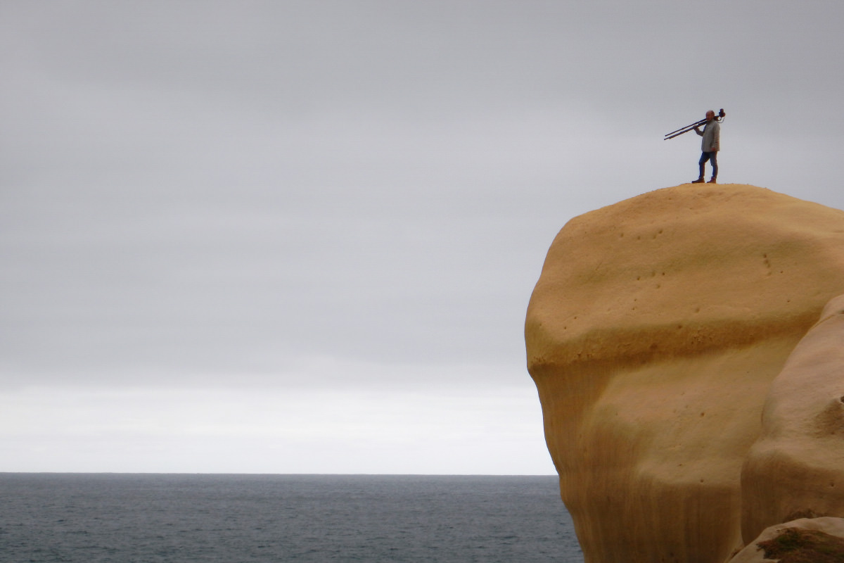 ダニーデンの絶壁に立つ高砂。激しい風雨で岩肌が丸みを帯びている。この海の向こうに南極があるのだ。この下に前出の「トンネルビーチ」がある。